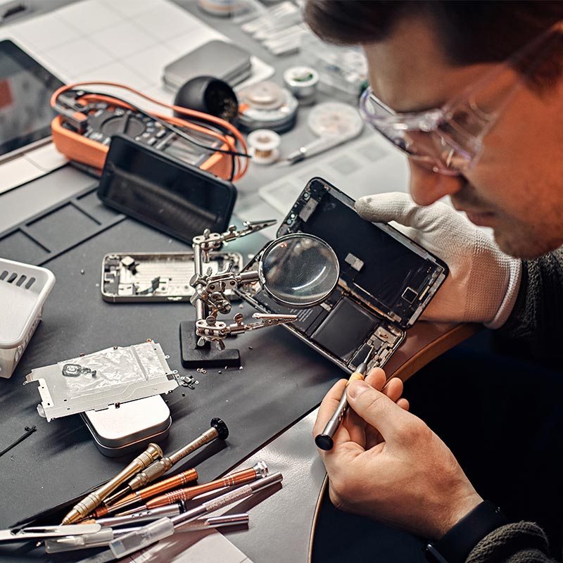 URPhone Store technician evaluating a customer's phone for trade-in in Orlando